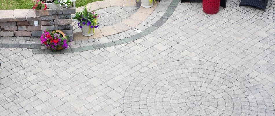 Patterned paver patio in Brownstown, PA, with flowers.