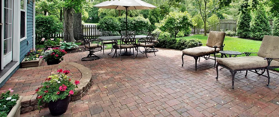 Paver patio in Landisville, PA, with chairs and landscaping plants.